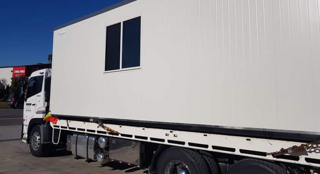 Ace Portable Building on a transport truck